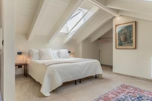 a bedroom with a large bed and a skylight at Luxury 2BR w/ River Castle View in Borgo Valsugana in Borgo