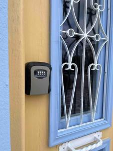 a window with a temperature meter on the side of a house at Casa Piaduli in Faliraki