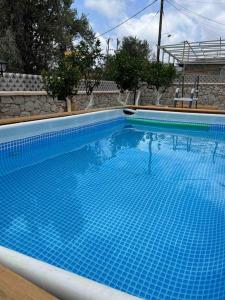 a large swimming pool with blue tiles on it at Casa Piaduli in Faliraki