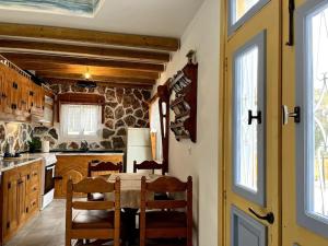 a kitchen with a table and chairs in a room at Casa Piaduli in Faliraki
