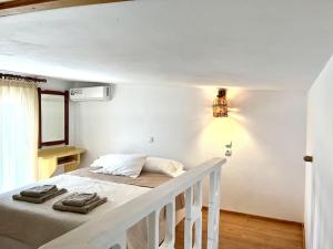 a white bedroom with a bed in a room at Casa Piaduli in Faliraki +47 photos