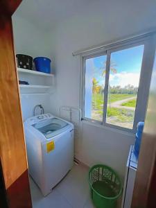 a washing machine in a bathroom with a window at Duplex,near the Beach plus airport in Punta Cana