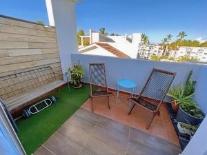 a patio with a bench and chairs on a balcony at Duplex,near the Beach plus airport in Punta Cana