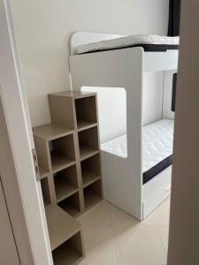 a small white bunk bed in a room at 2 Bedroom flat Shengjin in Margjonaj +11 photos