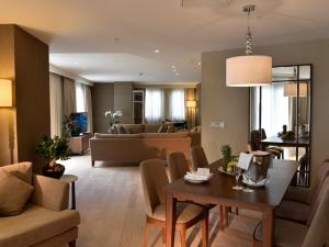 a living room with a couch and a table at CVK Park Bosphorus Hotel Istanbul in Istanbul