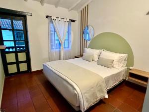 a bedroom with a large bed and a window at Casa Ande Hotel boutique in Villa de Leyva +64 photos