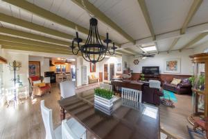 a dining room and living room with a dining table at Redwood Hollow Cottages in San Diego