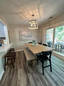 a dining room with a wooden table and chairs at 3 BR Villa Perfect for Families and Friends in Sea Pines, Hilton Head in Hilton Head Island