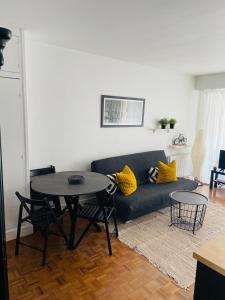 a living room with a couch and a table at Appart Grande terrasse in Saint-Jean-de-Luz