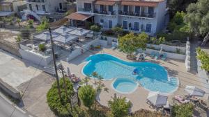 an overhead view of a swimming pool in front of a house at Irida Studios and Suite in Paleokastritsa