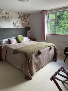 a bedroom with a bed and a window at Muckross Riding Stables in Killarney