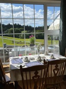a table in a room with a large window at Muckross Riding Stables in Killarney