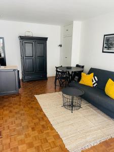 a living room with a couch and a table at Appart Grande terrasse in Saint-Jean-de-Luz +5 photos