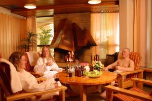 a group of people sitting around a table in a room at Hotel Ivalo in Ivalo