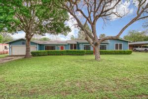 a house with two trees in a yard at Zipp Away LD 728 in New Braunfels