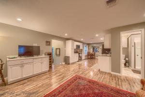 a large kitchen with white cabinets and a red rug at Zipp Away LD 728 in New Braunfels