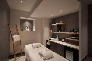 a room with a bed and a counter with a meditation room at Best Western Plus La Demeure in Paris