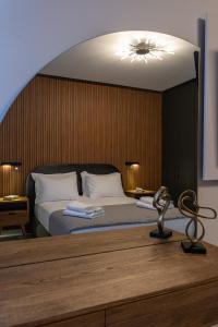 a bedroom with a bed with a light above it at Laskaris Luxury Apartment in Kalamata