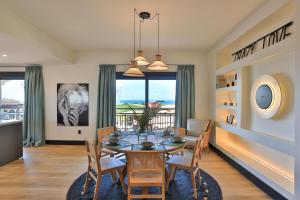 a dining room with a table and chairs at Designers Delight 3 BR w Pool Gym Tennis Courts in Cupecoy
