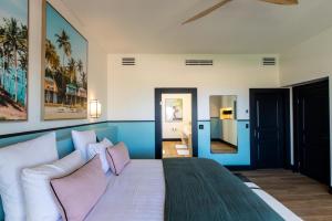 a bedroom with a large bed with pink pillows at Designers Delight 3 BR w Pool Gym Tennis Courts in Cupecoy +36 photos