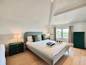 a bedroom with a large bed and a window at POOL, Panoramic VIEW Authentic Village Villa in Saint-Jeannet