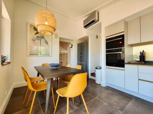 a kitchen and dining room with a table and chairs at POOL, Panoramic VIEW Authentic Village Villa in Saint-Jeannet +91 photos