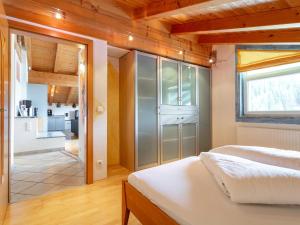 a bedroom with a bed and a glass wall at Appartement Schwab in Hopfgarten im Brixental