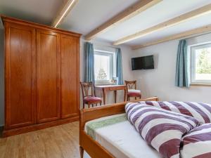 a bedroom with a bed and a dining room table at Appartement Schwab in Hopfgarten im Brixental