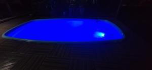 una bañera azul sentada en un suelo de madera en una habitación oscura en Pousada e Hostel Espaço Sairé en Alter do Chao