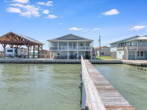 a house on the water with a dock at Shore Better Than Work in Rockport