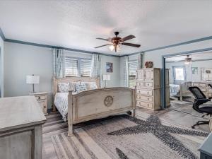 a bedroom with a bed and a ceiling fan at Shore Better Than Work in Rockport