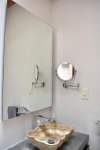 a bathroom with a wooden sink and a mirror at CASAS FREDA - Centro Historico Departamentos in San Luis Potosí +21 photos