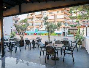 a row of tables and chairs on a patio at Vila Franko in Berat