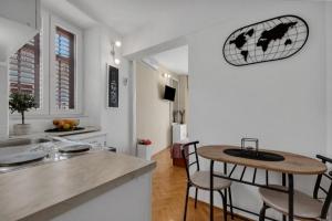 a kitchen with a table and chairs in a room at Apartments and rooms by the sea Podgora, Makarska - 2623 in Podgora