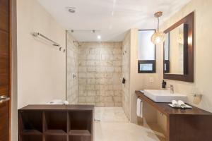a bathroom with a sink and a shower at KAHATSA' boutique hotel in Tulum
