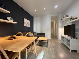 a living room with a dining table and a television at Stay U-nique Apartments Rossello in Barcelona