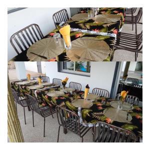 a dining room with a table and chairs with umbrellas at Le GANGA LODGE in Ndangane