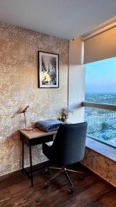 a desk with a chair in a room with a window at Centaurus Apartment City View One Bed Studio in Islamabad +12 photos