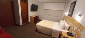 A television and/or entertainment centre at HOTEL Javier Prado Inn