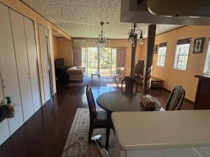 a living room with a dining room table and chairs at Rose Garden Esta in Kashiwa