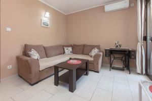 a living room with a couch and a table at Andrea Beachside Apartment in Risan +10 photos