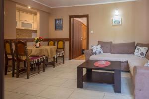 a living room with a couch and a table at Andrea Beachside Apartment in Risan