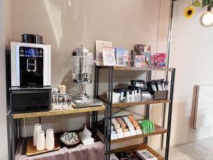 a shelf with a coffee maker and a microwave at Dynasty Hotel & Resort Osaka in Osaka
