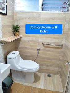 a bathroom with a white toilet and a sink at Baguio Dreamz - Transient in Baguio +50 photos