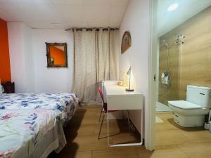 a bedroom with a bed and a sink and a toilet at Mirador 2 del Mercado Central - habitacion con baño privado en el centro de la Ciudad Vella in Valencia