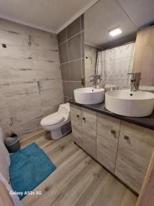 a bathroom with two sinks and a toilet in it at La RUCA DEL VIAJERO in Valdivia +40 photos