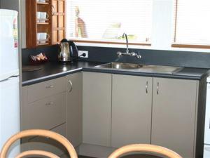 a kitchen with a sink and a counter top at Apostles View Motel in Greymouth