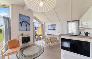 a kitchen and dining room with a table and chairs at Friedrichskoog-Deichblick 20 in Friedrichskoog