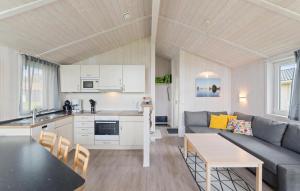 a kitchen and living room with a couch and a table at Friedrichskoog-Deichblick 20 in Friedrichskoog