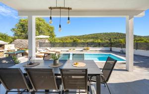 a patio with a table and chairs and a swimming pool at Stunning Home In Krusevo in Kruševo